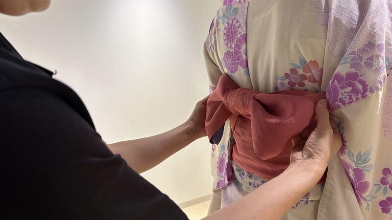 The process of getting dressed in a kimono